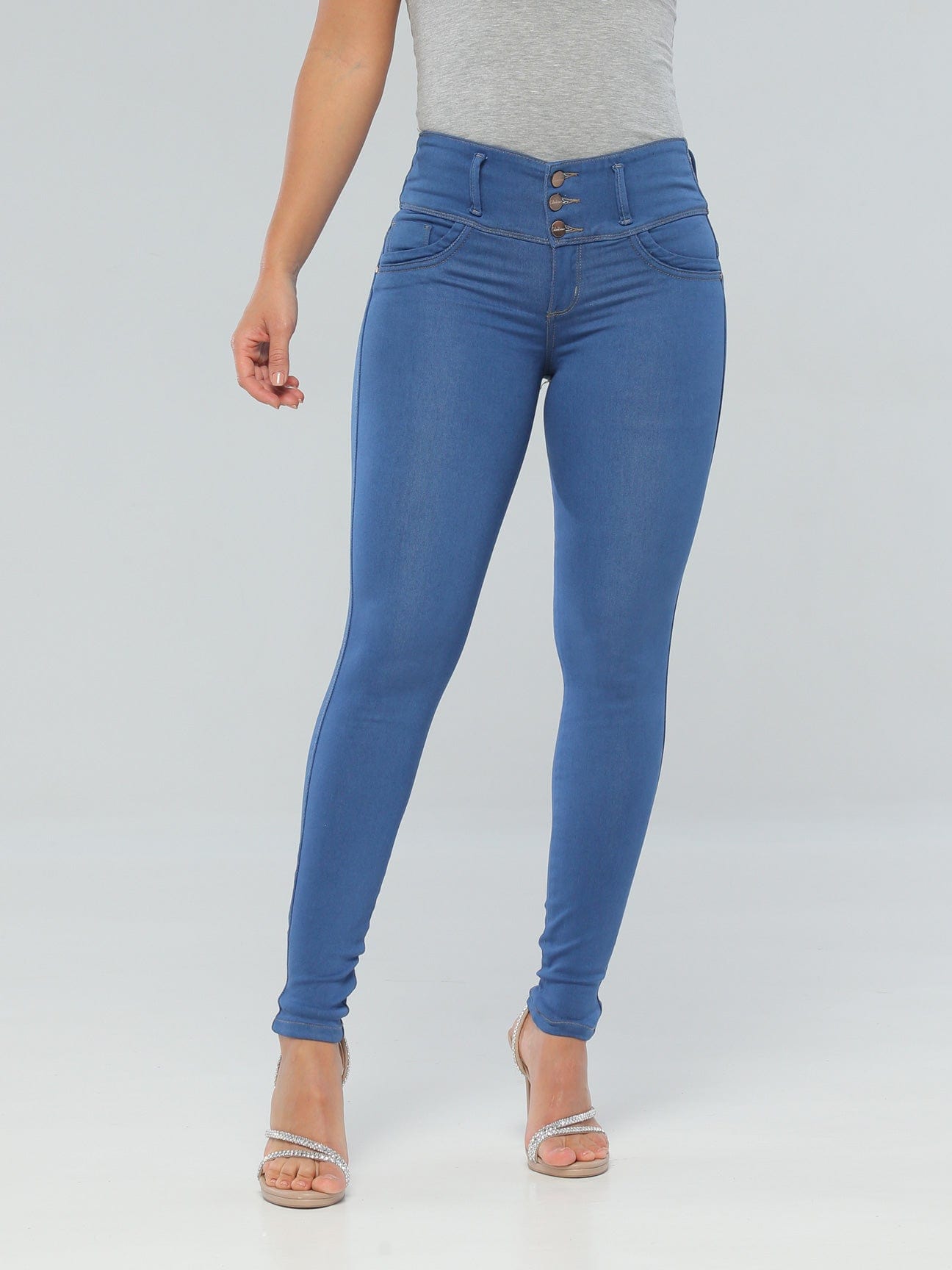 Latina woman wearing high-waisted skinny blue butt lift jeans with thick waistband.