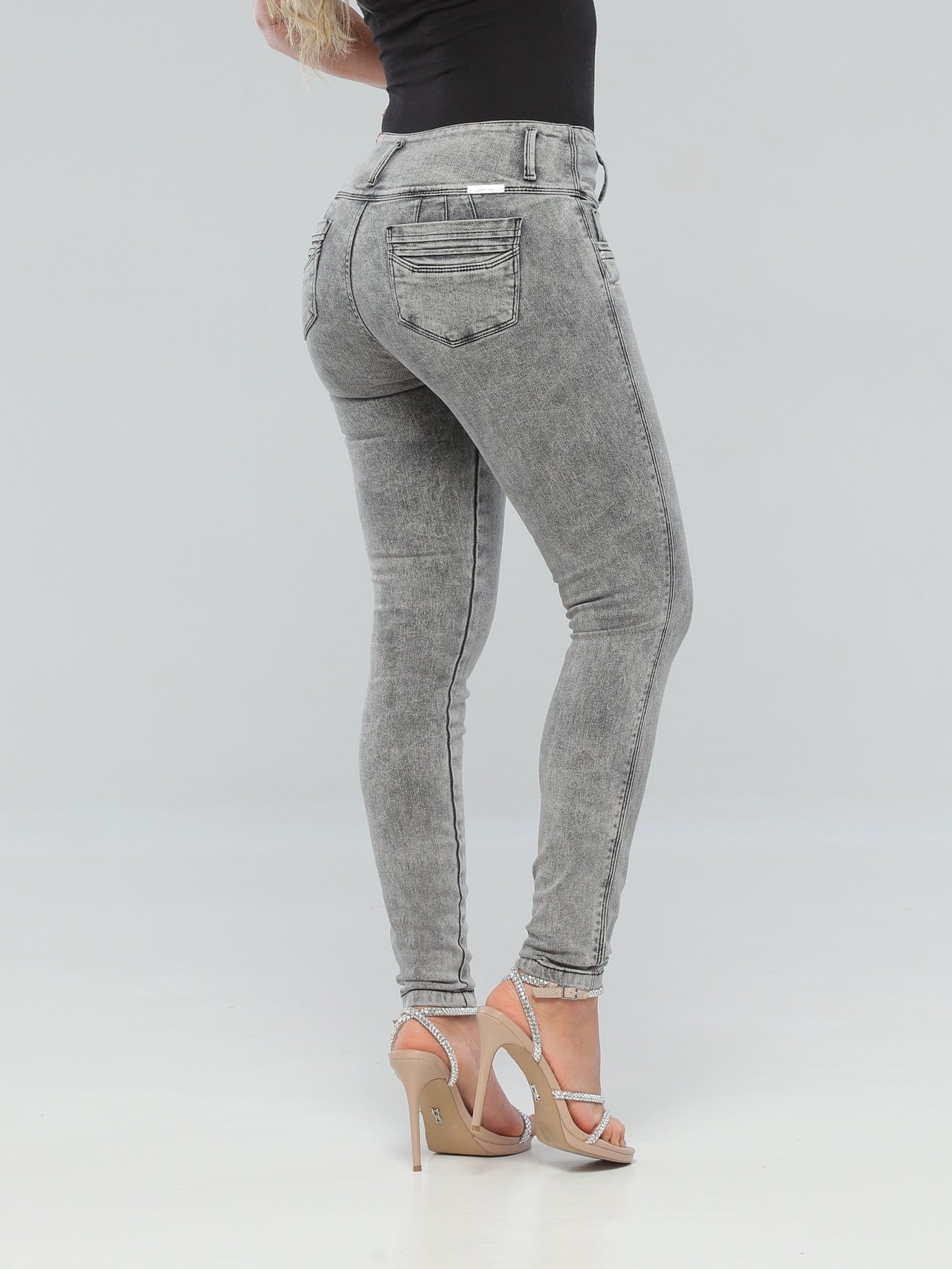 Back view of a woman in high-waisted grey butt lift jeans, featuring a thick waistband and 3D pockets.