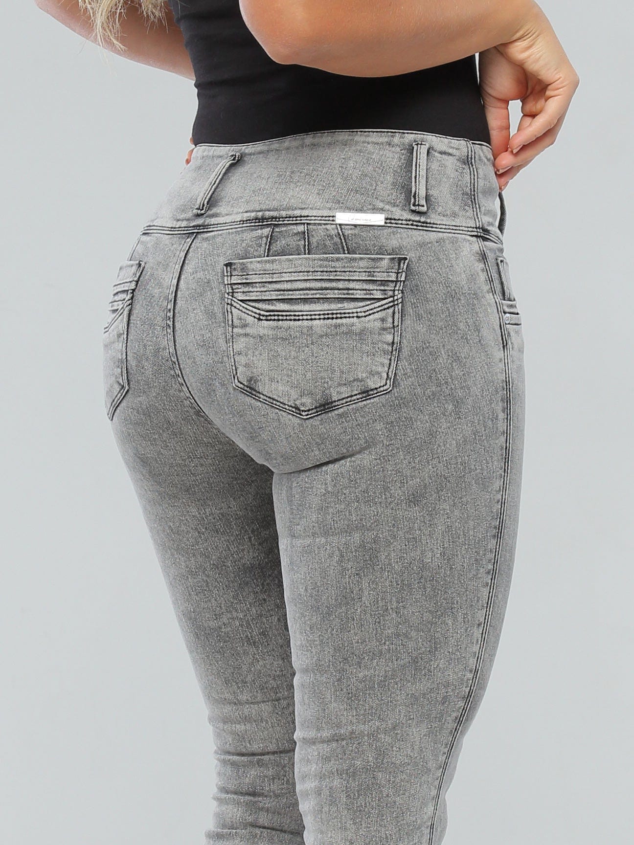 Butt lift high-waisted jeans with a buttoned waist, thick waistband, and no gap, showcasing a sleek skinny fit and 3D pockets.