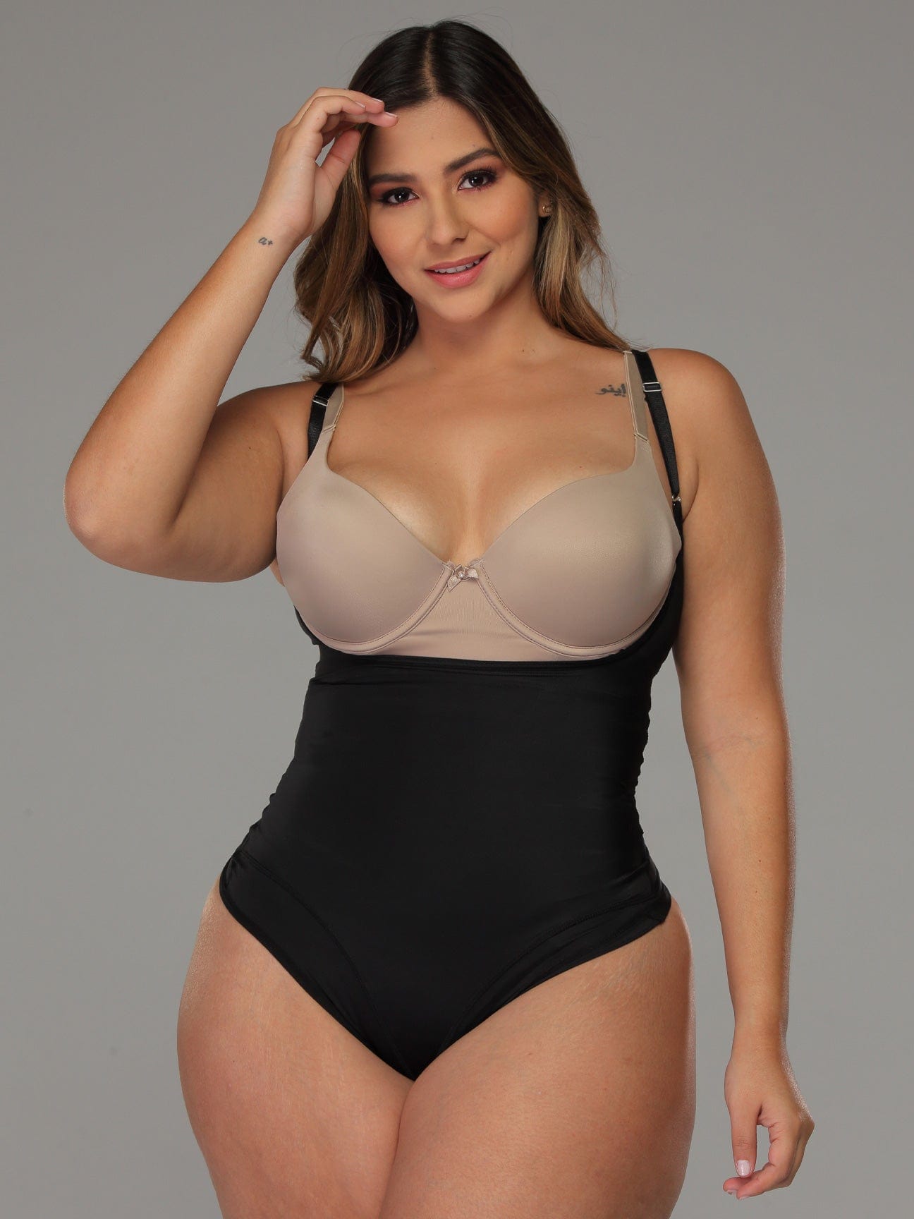 Full front view of black Tummy Smoothing Faja Bodysuit with plus sized model.