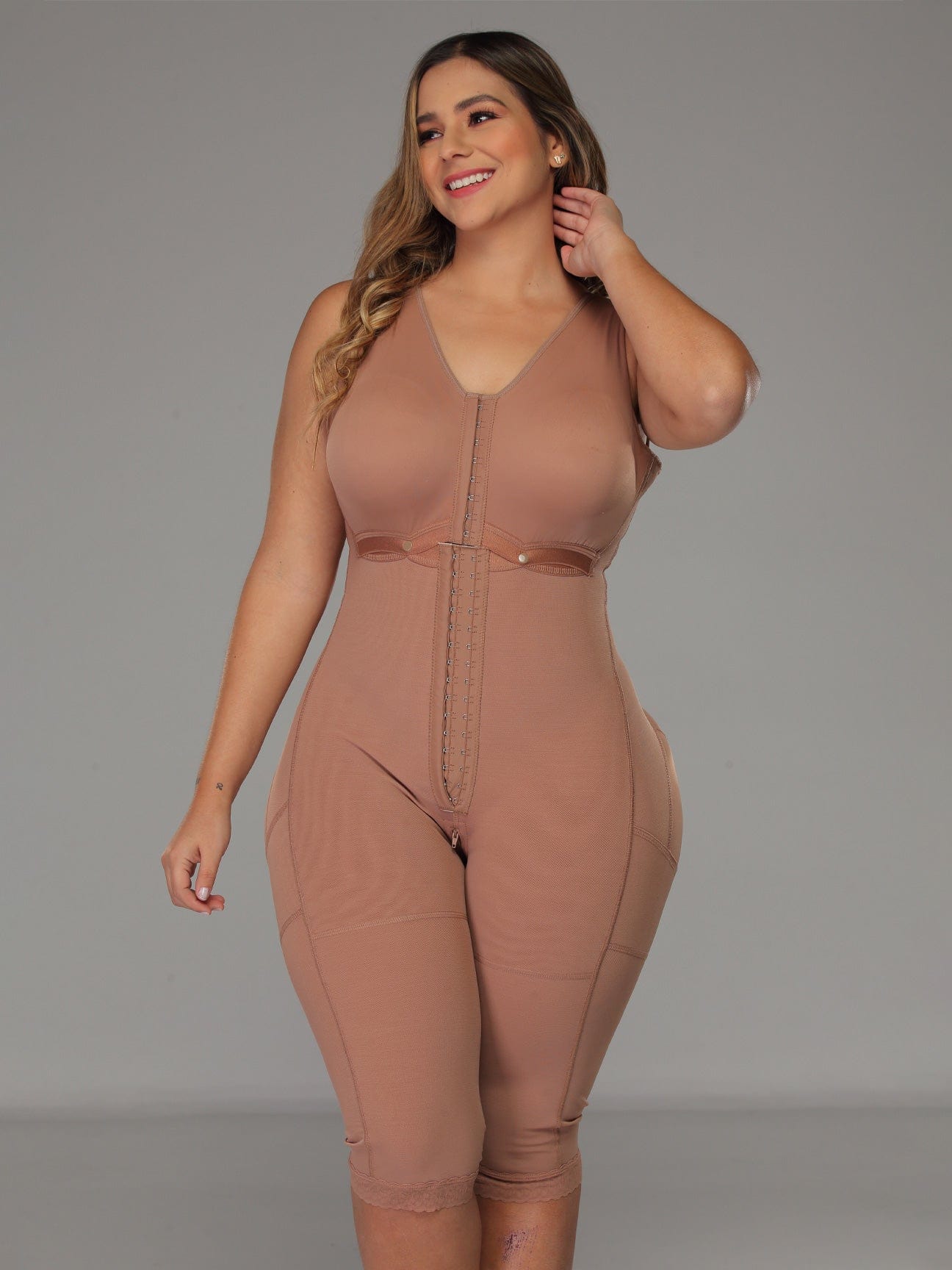 Fully body view of a brown colored brown colored full body faja with bra and hooks.